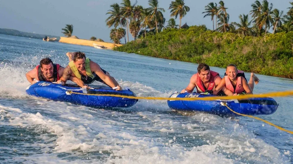 Tourists enjoying inflatable tubing water sport in Manda Bay, Lamu, Kenya